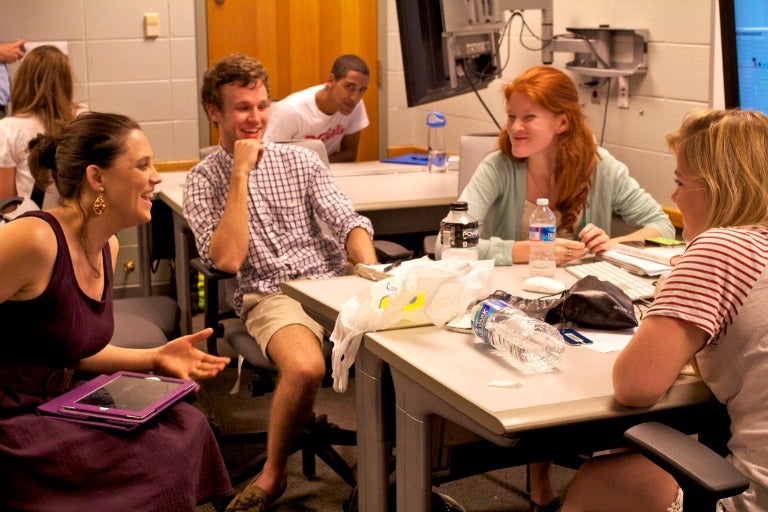 Students laughing in a classroom.